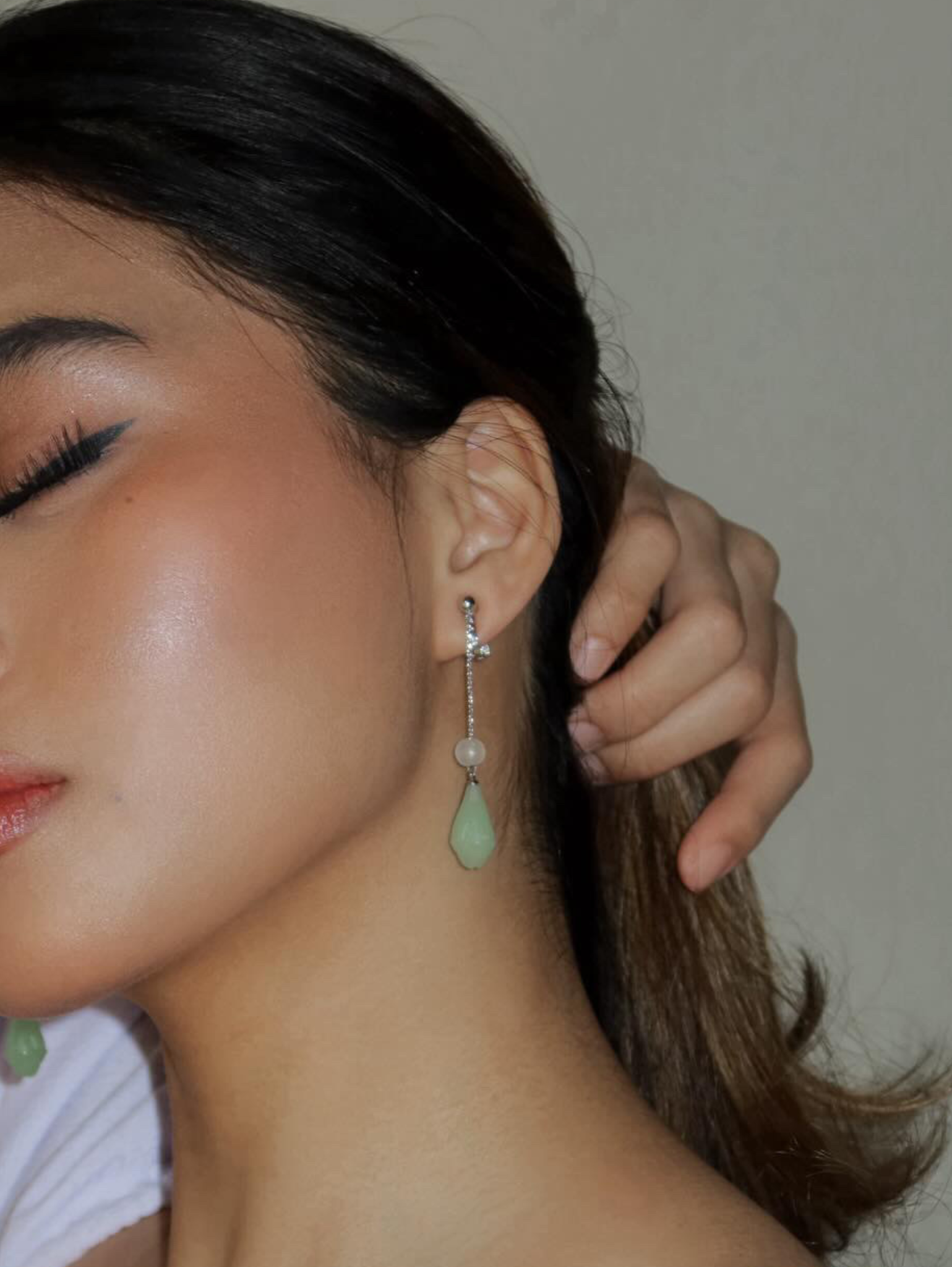 gold long chain clipon earrings with jade charm on model
