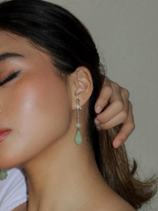 gold long chain clipon earrings with jade charm on model