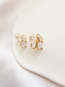 gold & white cubic zirconia shaped into a flower atop a square gem clipon earrings