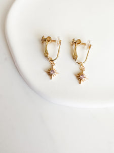 gold screwback clipon earrings with gold constellation charm with light pink circle gem in middle