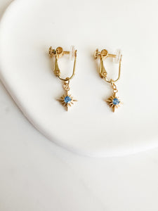 gold screwback clipon earrings with gold constellation charm with light blue circle gem in middle