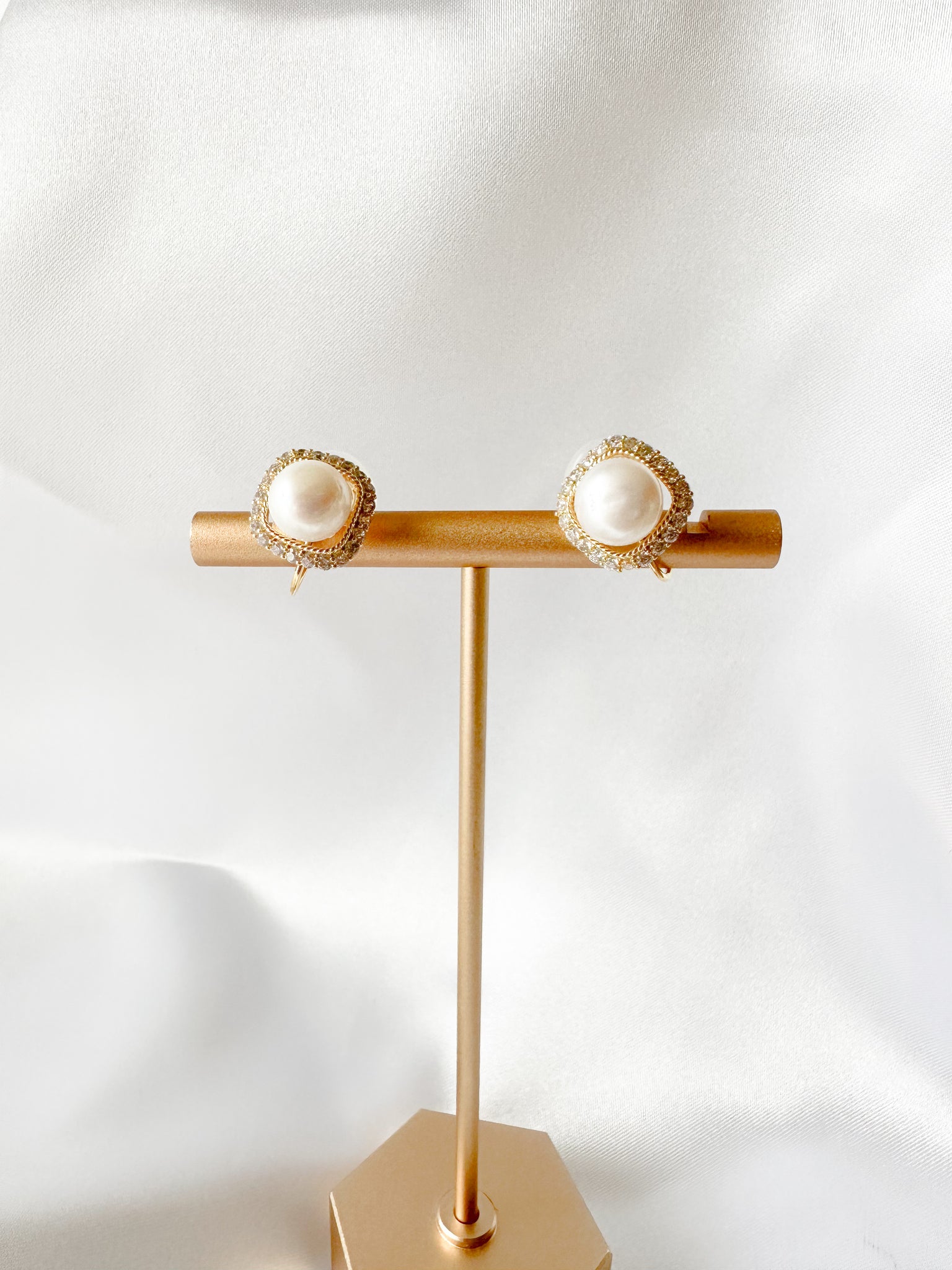 pearl clip-on earrings with tiny gems surrounding perimenter