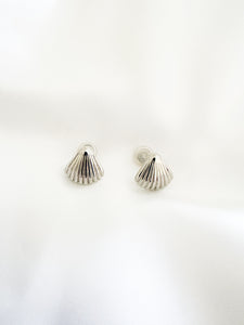 Silver shell-shaped earrings on a white background
