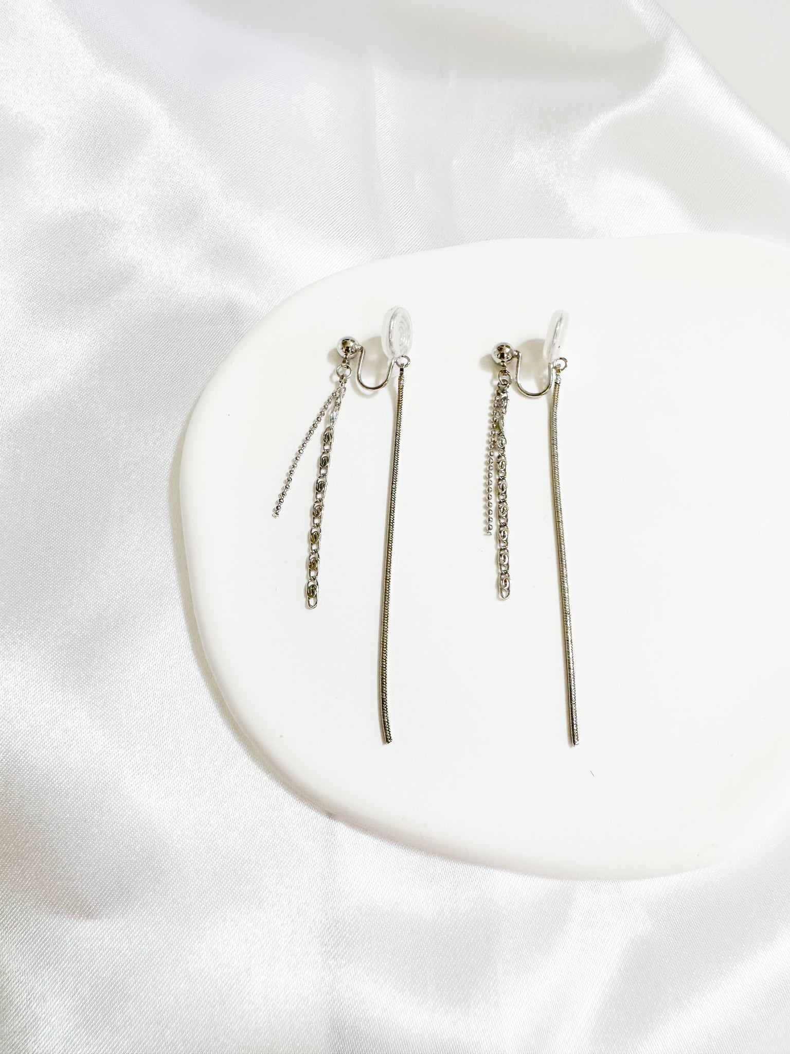 A pair of silver-colored threader dangle earrings