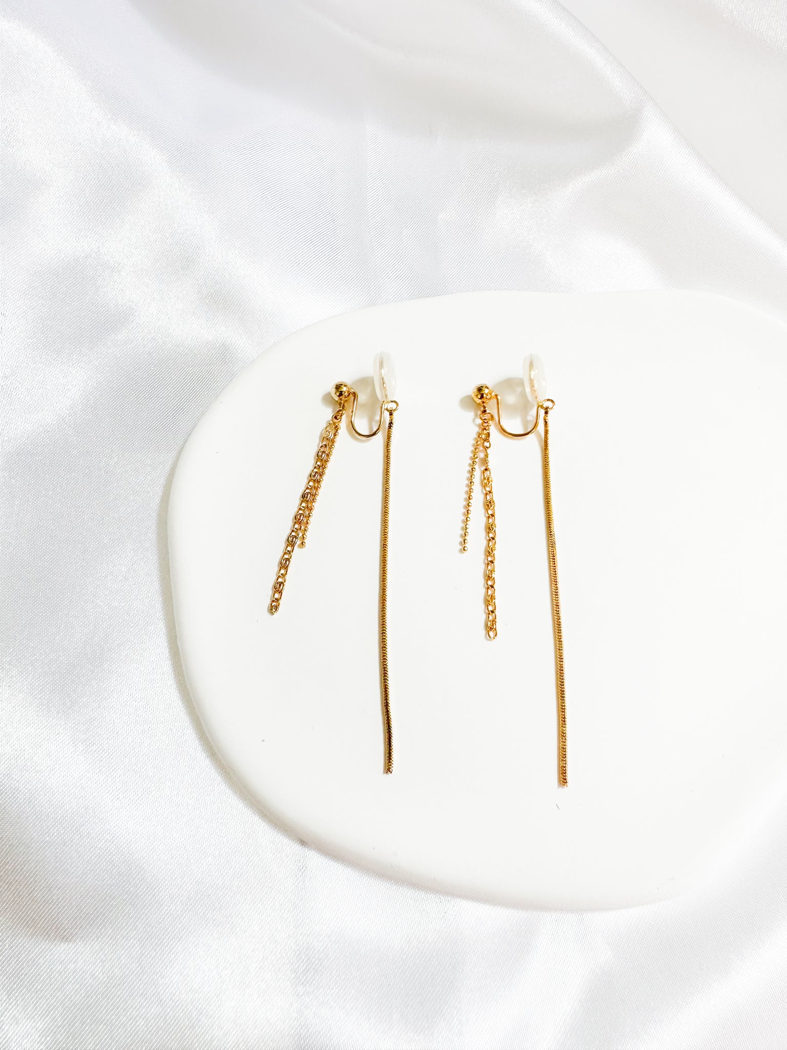 A pair of gold-colored threader dangle earrings