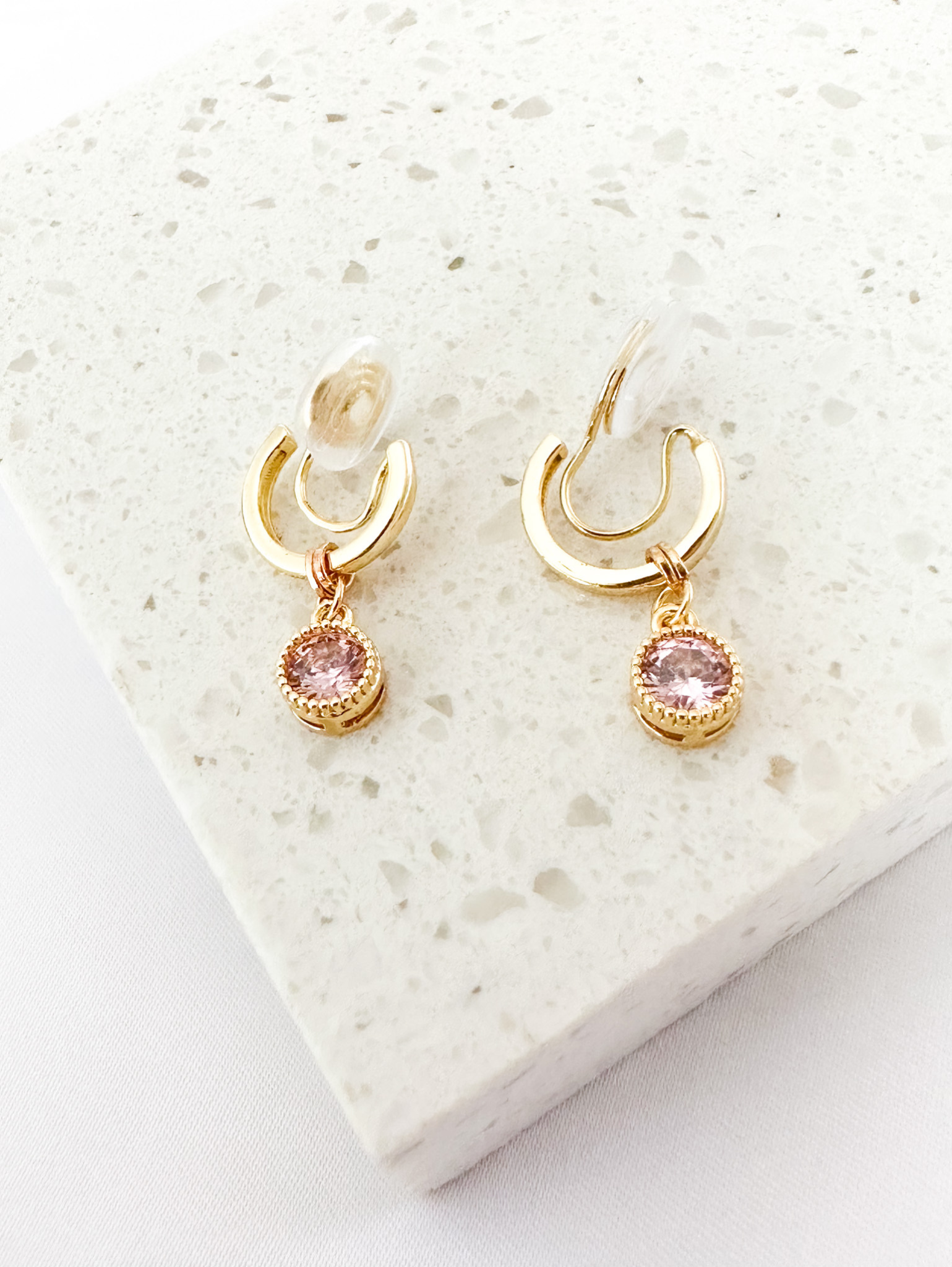 small gold clip-on hoop earrings with pink circle charm