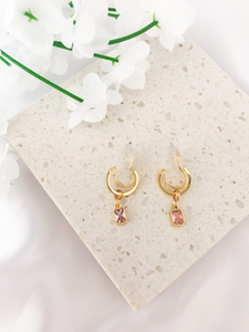 small gold clip-on hoop earrings with pink rectangle charm