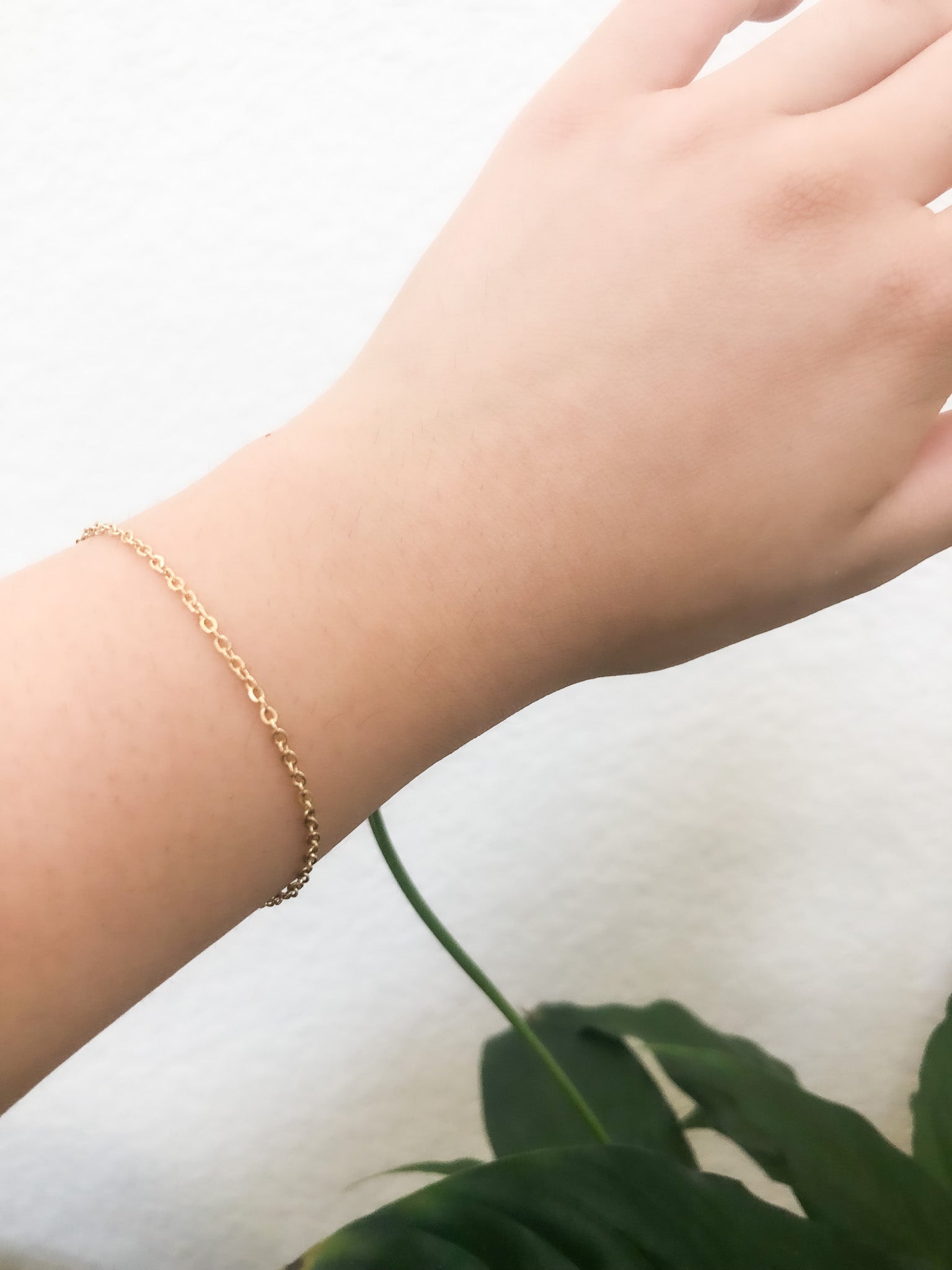Elevate your jewelry game with our dainty gold bracelet, a versatile and stylish accessory perfect for any occasion. The bracelet features a delicate gold-tone chain with a small gold charm, measuring approximately 0.5 inches in length. The dainty chain measures approximately 7 inches in length, making it the perfect length for layering or wearing on its own. The timeless gold-tone finish adds a touch of elegance to any outfit and is suitable for both casual and formal occasions. 