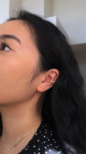 gold butterfly ear cuff on model