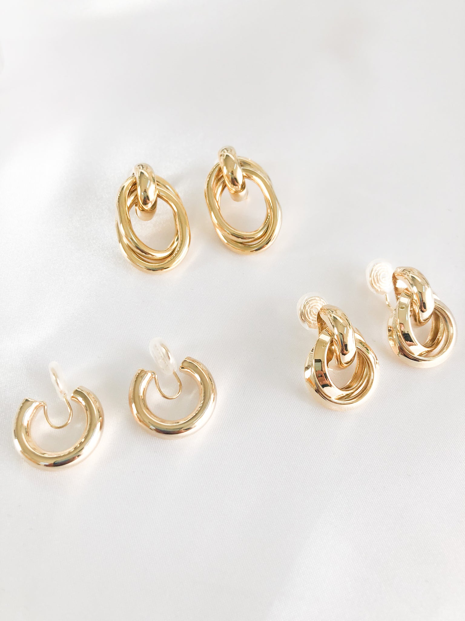 Add some glam to your wardrobe with our bundle of different gold clip-on hoop earrings. This set features four pairs of earrings, each with a unique design. Amy Clip-on Hoops, Allie Clip-on Hoops, and Estelle Clipon Hoops