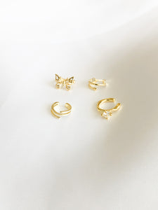 Upgrade your jewelry game with our stunning bundle of gold ear cuffs, featuring a gold butterfly ear cuff, a gold 3 banded layered ear cuff, a gold 3 banded layered ear cuff with star and one gem, and a gold cuff with cubic zirconia gem. All cuffs are designed for a comfortable and secure fit, perfect for those without pierced ears.